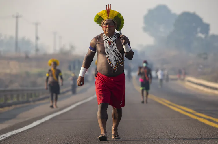 Indigenous protester walks on a highway