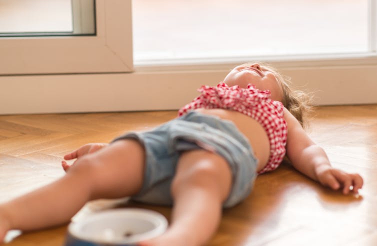 Child laying on floor