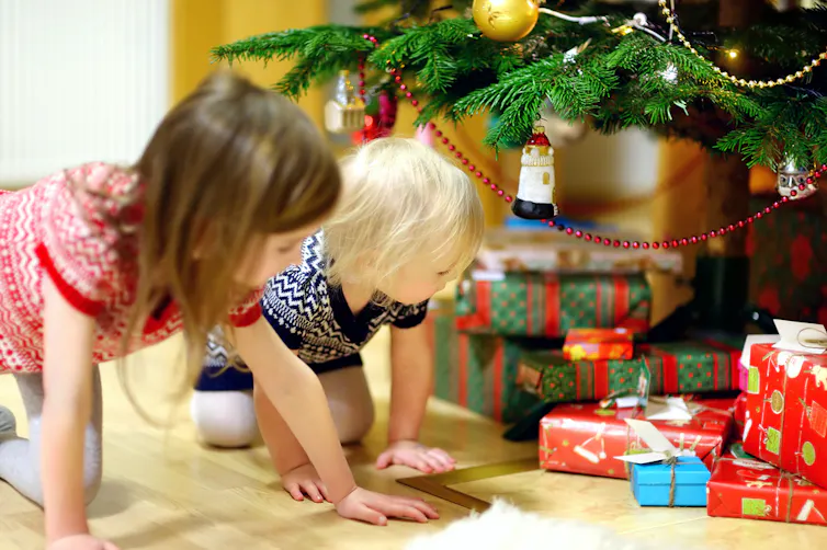 Children looking at presents under the tree
