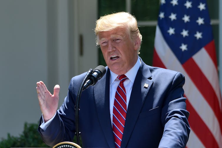 Donald Trump, as US president, gestures while speaking at a podium outside the White House