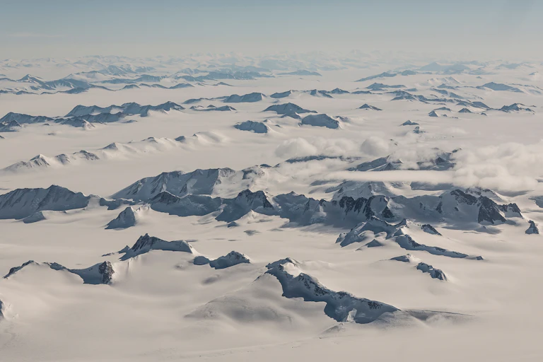 Mountains rise above ice
