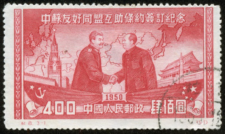 A stamp showing Joseph Stalin and Mao Zedong shaking hands, Chinese characters and the date 1950