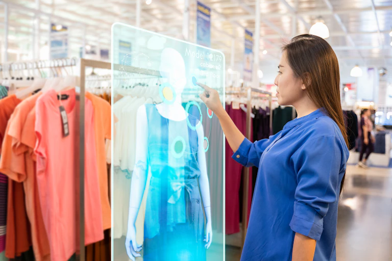 Woman uses touch screen in clothes store.