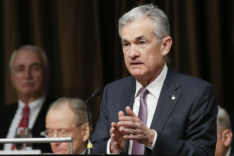 Jay Powell giving a speech with his hands together