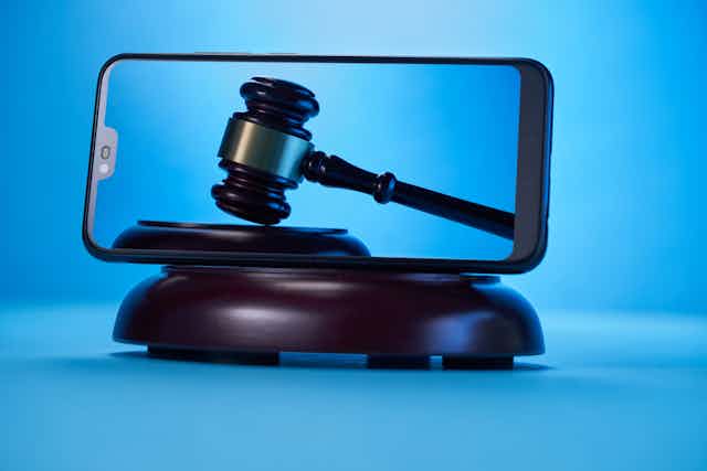A smartphone depicting a gavel propped on its side