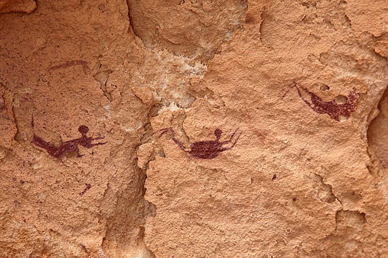 A cave painting showing swimmers.