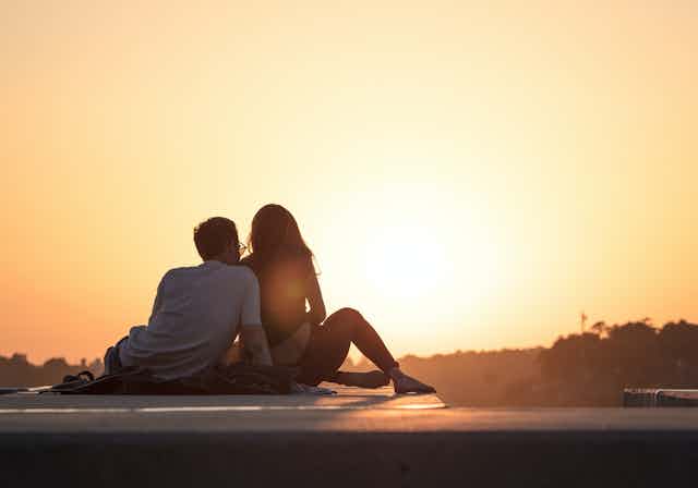 Young couple watch the sunset.