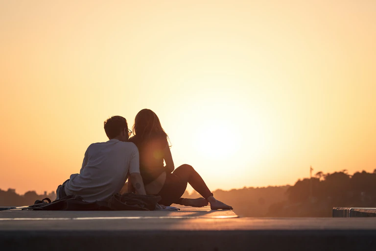 Young couple watch the sunset.