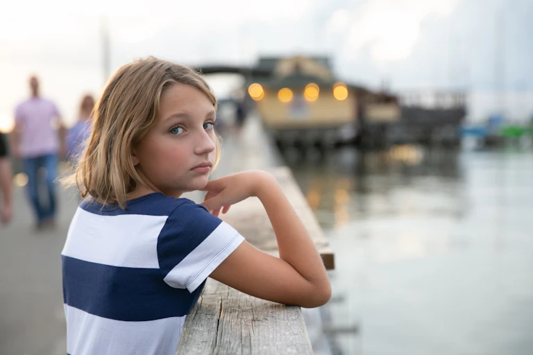 Pre-teen child at a jetty.
