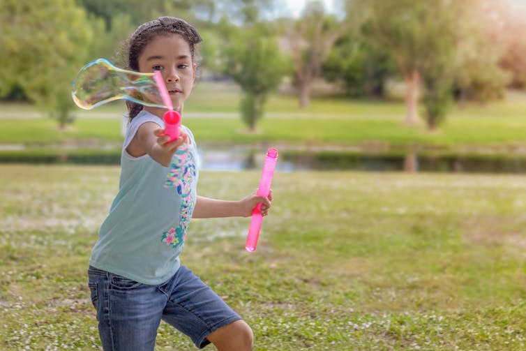 Girl uses bubble wand