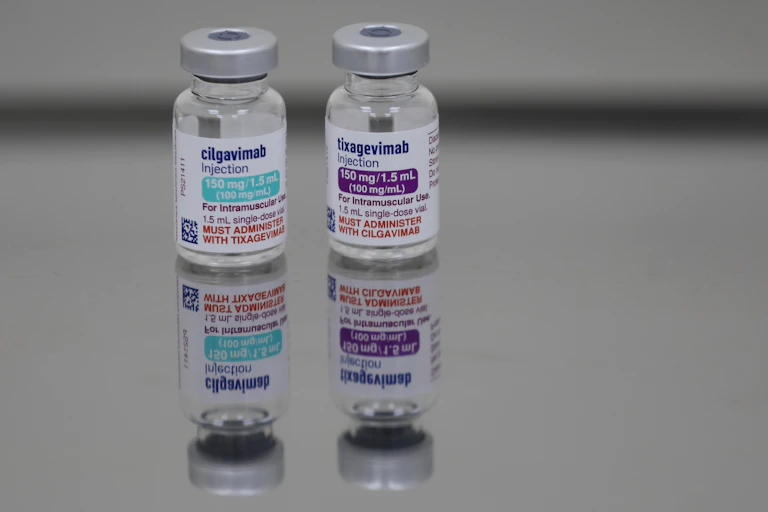 Empty vials of Evusheld sit on a table.