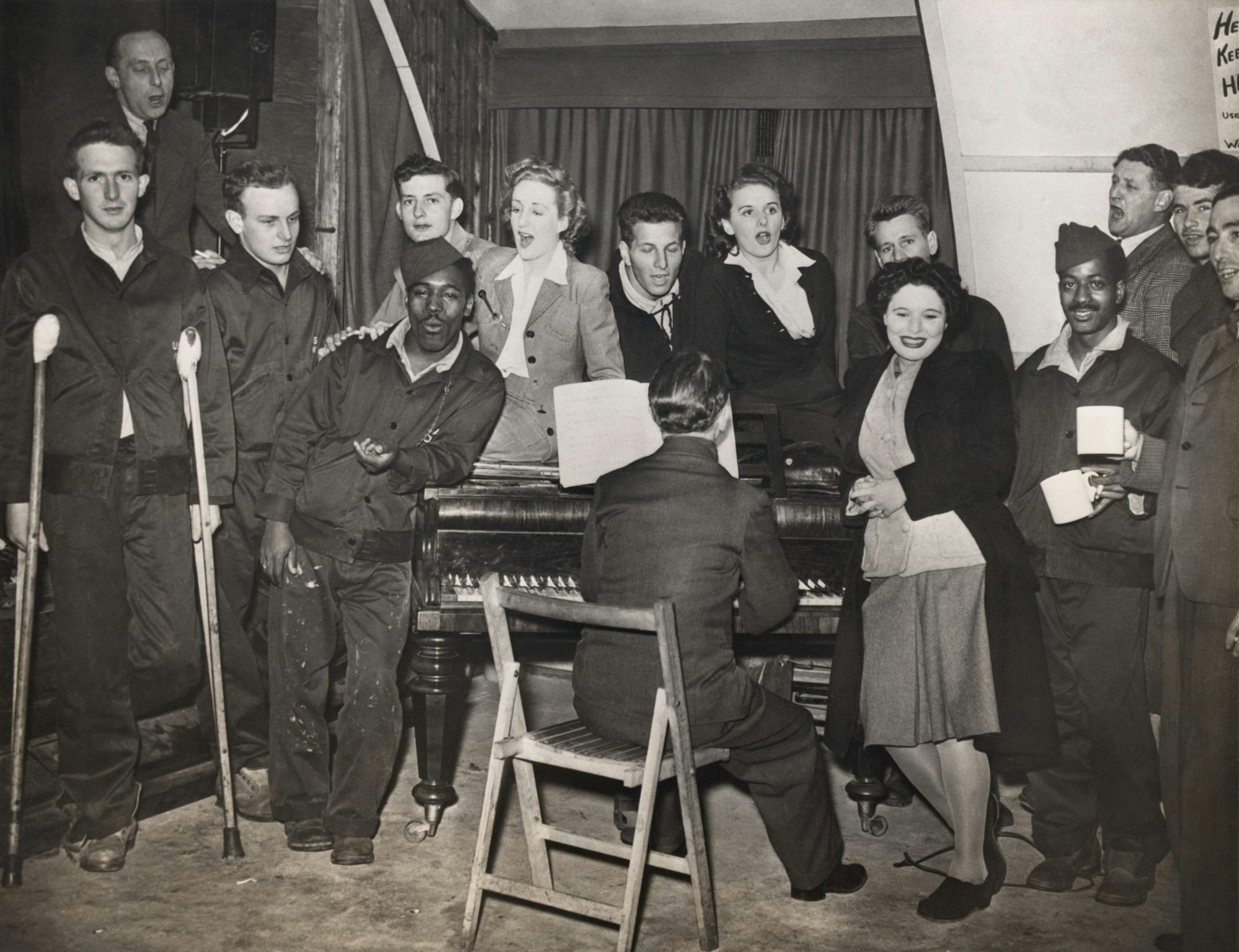 American GIs are entertained by pianist Horatio Davies, at a military hospital in West England.