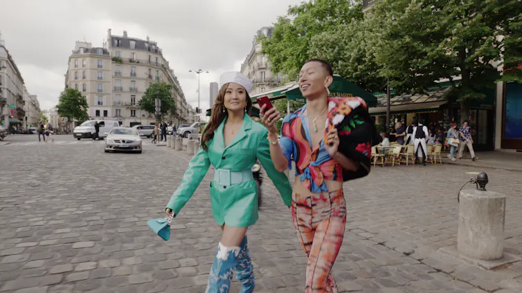Ashley Park and Jin Xuan Mao strolling through the streets of Paris.