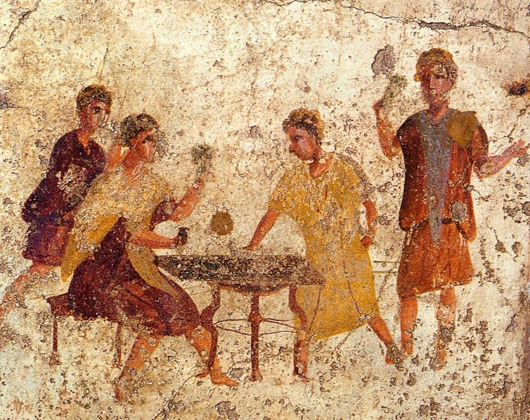 Fresco que representa a jugadores de dados de la antigua Roma.