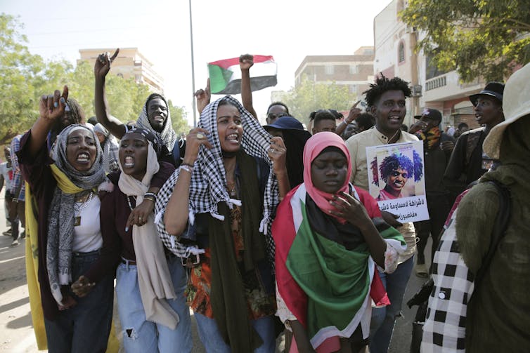 Young Black people are seen protesting in the streets.