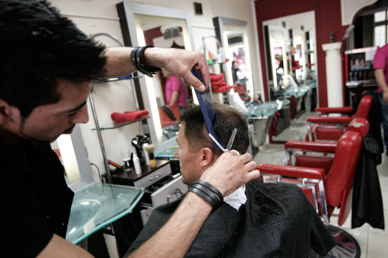 A man cuts another man's hair.