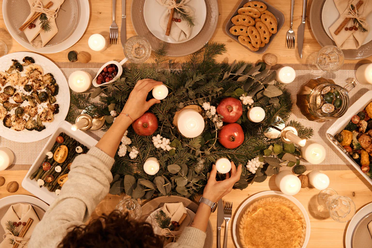 Table with fern leaves, candles and plates of food