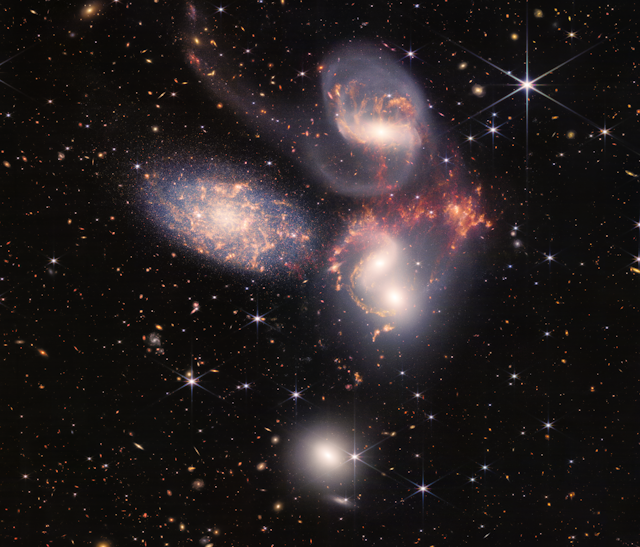 Three spiral galaxies against a backdrop of stars.