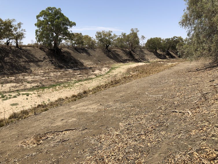 A dry, rocky riverbed stretches out.
