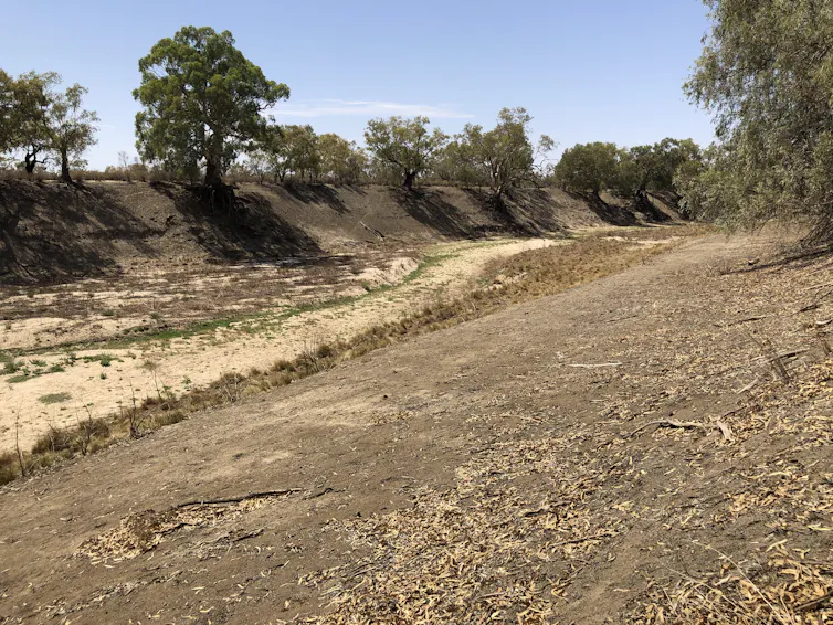 A dry, rocky riverbed stretches out.