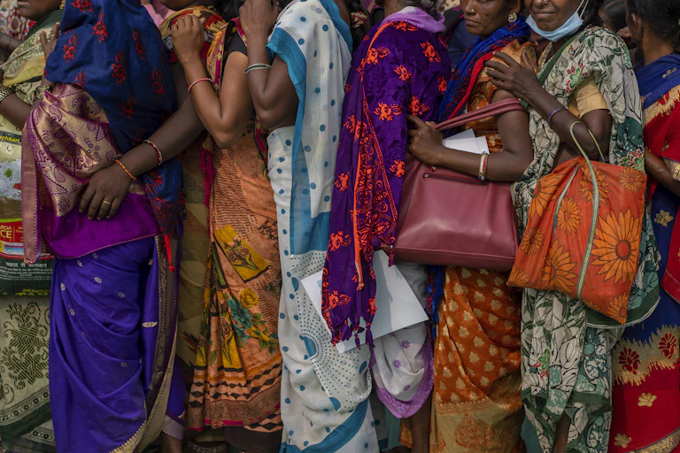 Indian women wait in a queue for a free medical check up camp held to mark Bhim Rao Ambedkar's death anniversary in Mumbai, India, Tuesday, Dec. 6, 2022.