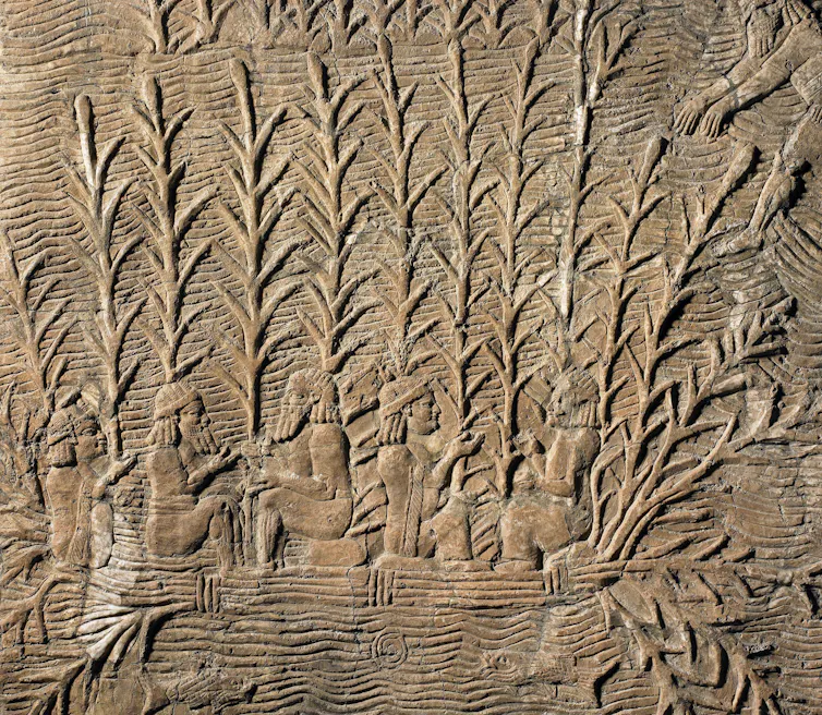 An ancient stone carving showing people in vegetation.