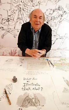 Sir Quentin Blake sitting at a table with his hands clasped.