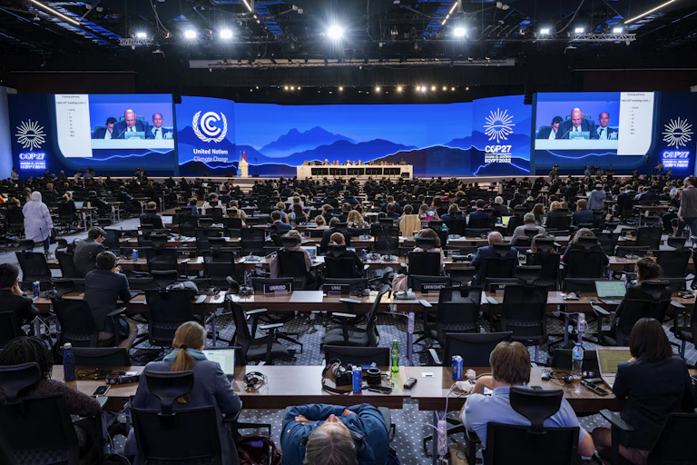 People seated in a large room for a meeting