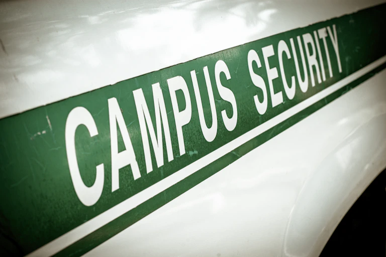 A police squard car is emblazoned with the words "Campus Security."