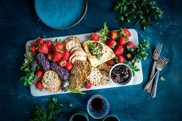 Platter of crackers, fruit and dips