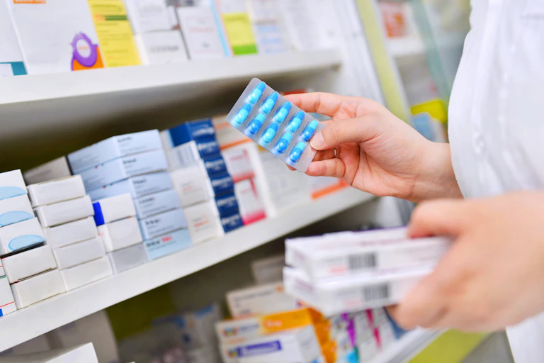 A pharmacist peruses medicines.