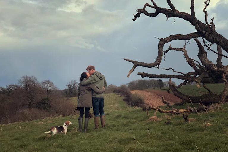 Harry and Meghan kiss during a dog walk in Windsor grounds.