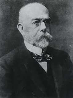 Black and white photograph of scientist Robert Koch, wearing spectacles and a large moustache.