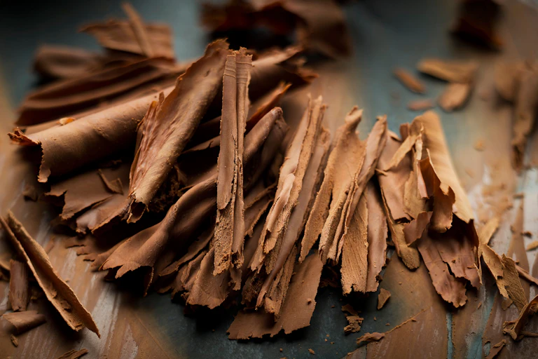 Some curled milk chocolate shavings.