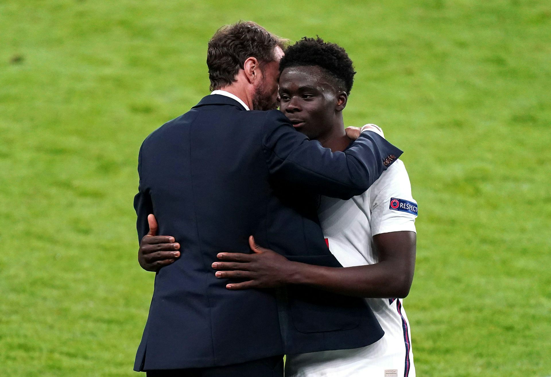 Footballer hugs his manager.