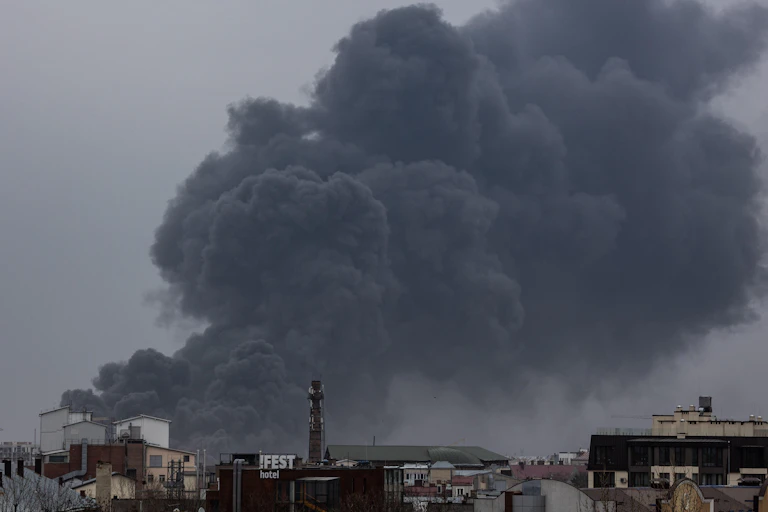 Smoke billowing out of a factory roof.
