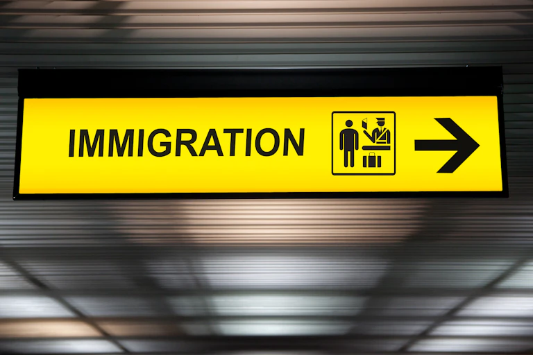A yellow sign with the word: immigration