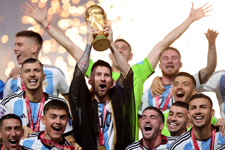 Lionel Messi holds the World Cup trophy.