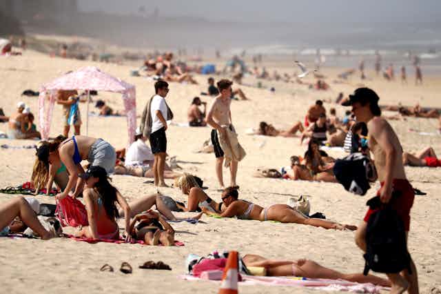 Beachgoers on the sand in the Gold Coast, Queensland