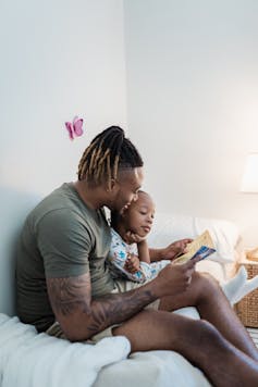 Dad reads his child a bedtime story
