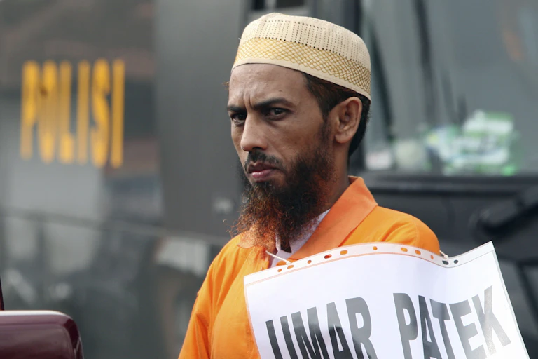 Man in skull cap and prison polo