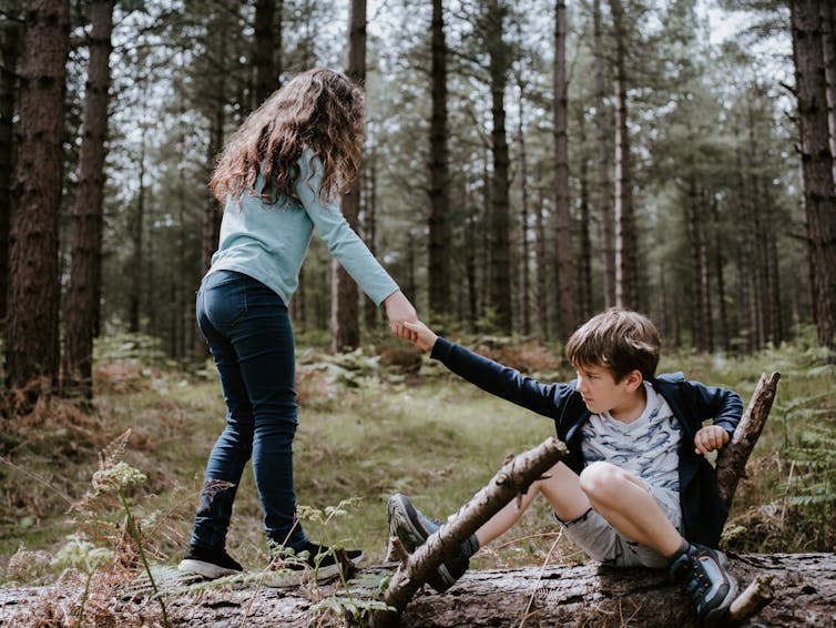 Child helps sibling up