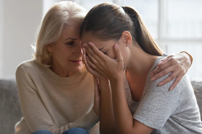Worry, older and younger women, comfort, embracing.