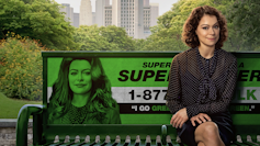 Jennifer Walters sits on a bench emblazoned with her She-Hulk alter ego's face.