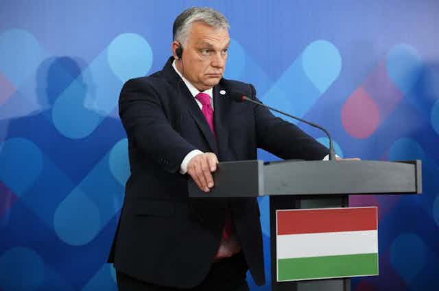 Viktor Orban standing at a lecturn.