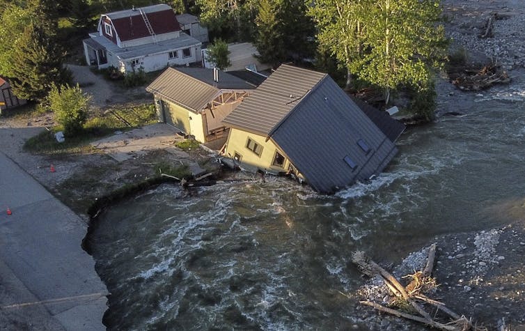 A house gets washed away by a raging river