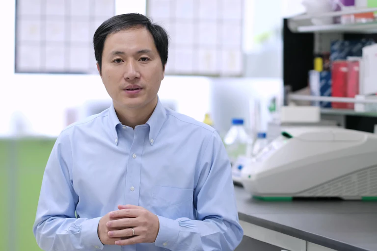 man in lab looks at camera