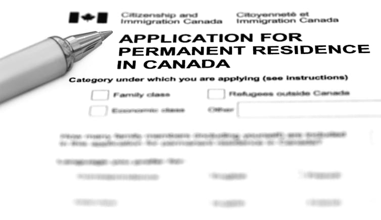 a pen next to an application form that reads: application for permanent residence in Canada