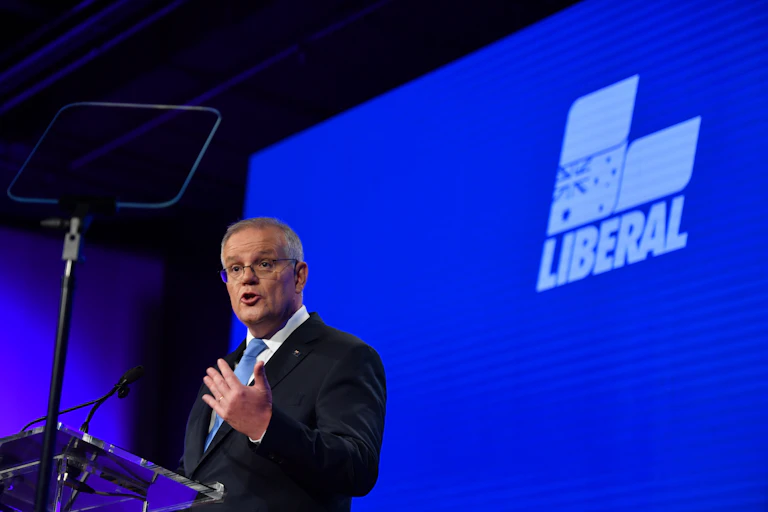 Former Australian Prime Minister Scott Morrison on stage in front of the Liberal Party logo