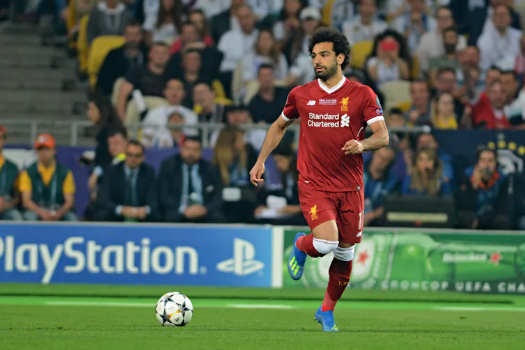 A man kicks a ball
